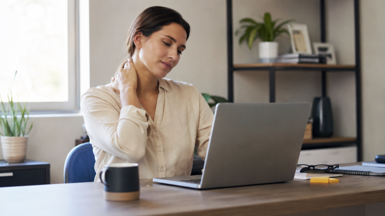 Mulher com desconforto no pescoço durante o trabalho no computador